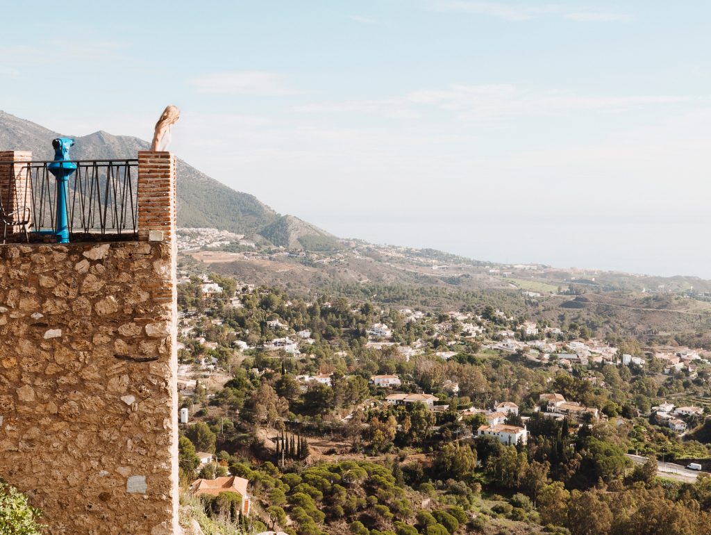 Mid adult woman standing on balcony, looking at view, Mijas, Andalucia, Spain Mid adult woman standing on balcony, looking at view, Mijas, Andalucia, Spain
